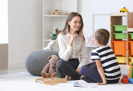 A therapist working on an child using therapy techniques for speech delay