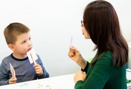 A therapist working on an child using speech and language therapy techniques
