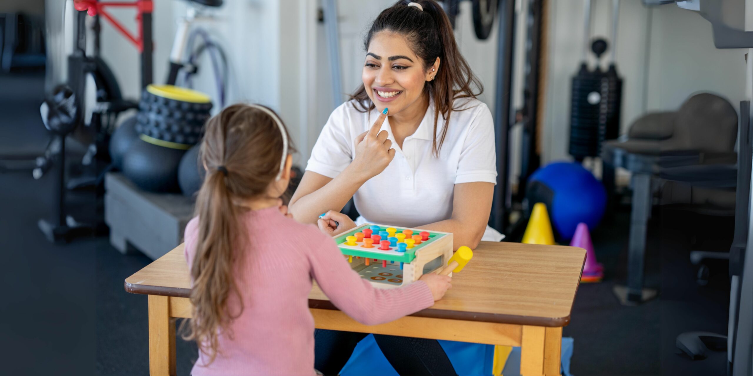 This is an image of a speech therapist working with a child during a speech therapy session, focusing on speech and language development.